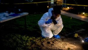 Investigator photographing crime scene evidence