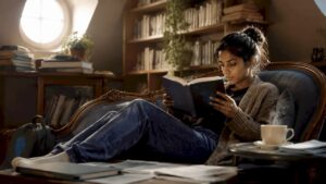 Woman reading cyber crime fiction book at home