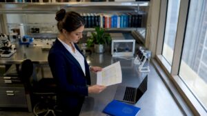 Forensic data examiner reviewing printed dataset