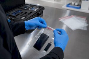 Hands sealing digital evidence in tamper-evident bag
