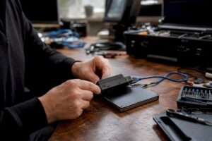 Hands connecting forensic device to hard drive