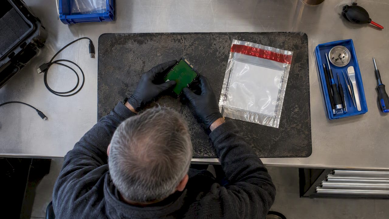 Day One Saves Evidence: Recover Lost Files for Legal Teams 1 Forensic examiner inspecting storage evidence